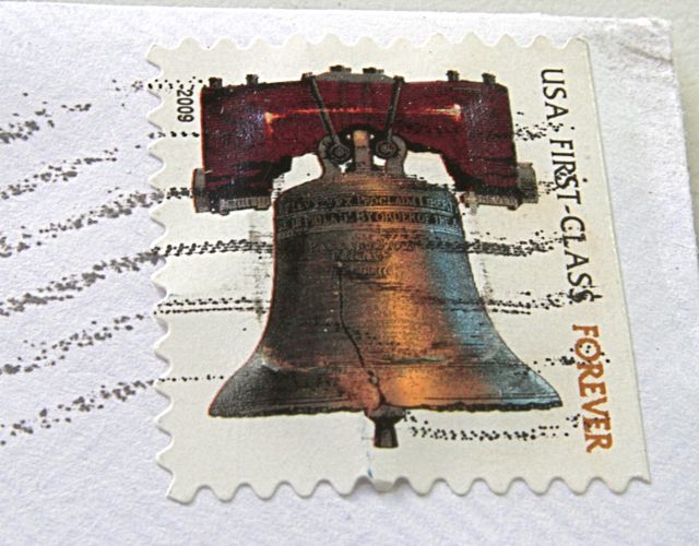 Postage stamp with a memory chip under it