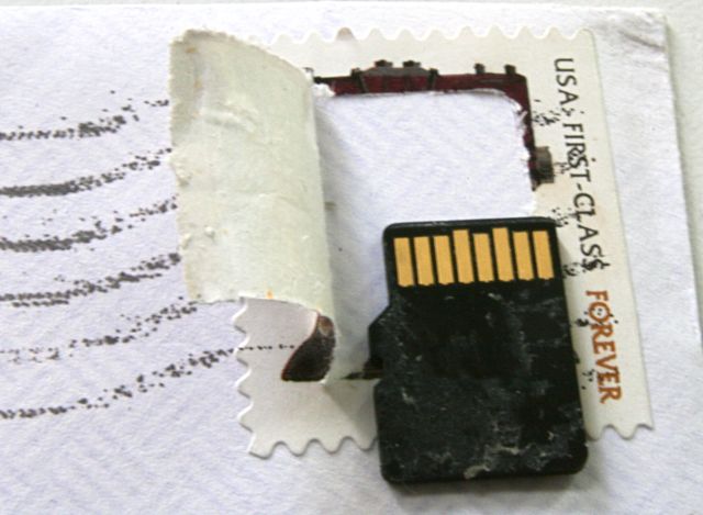 Postage stamp with a memory chip under it - cut open to reveal the stamp